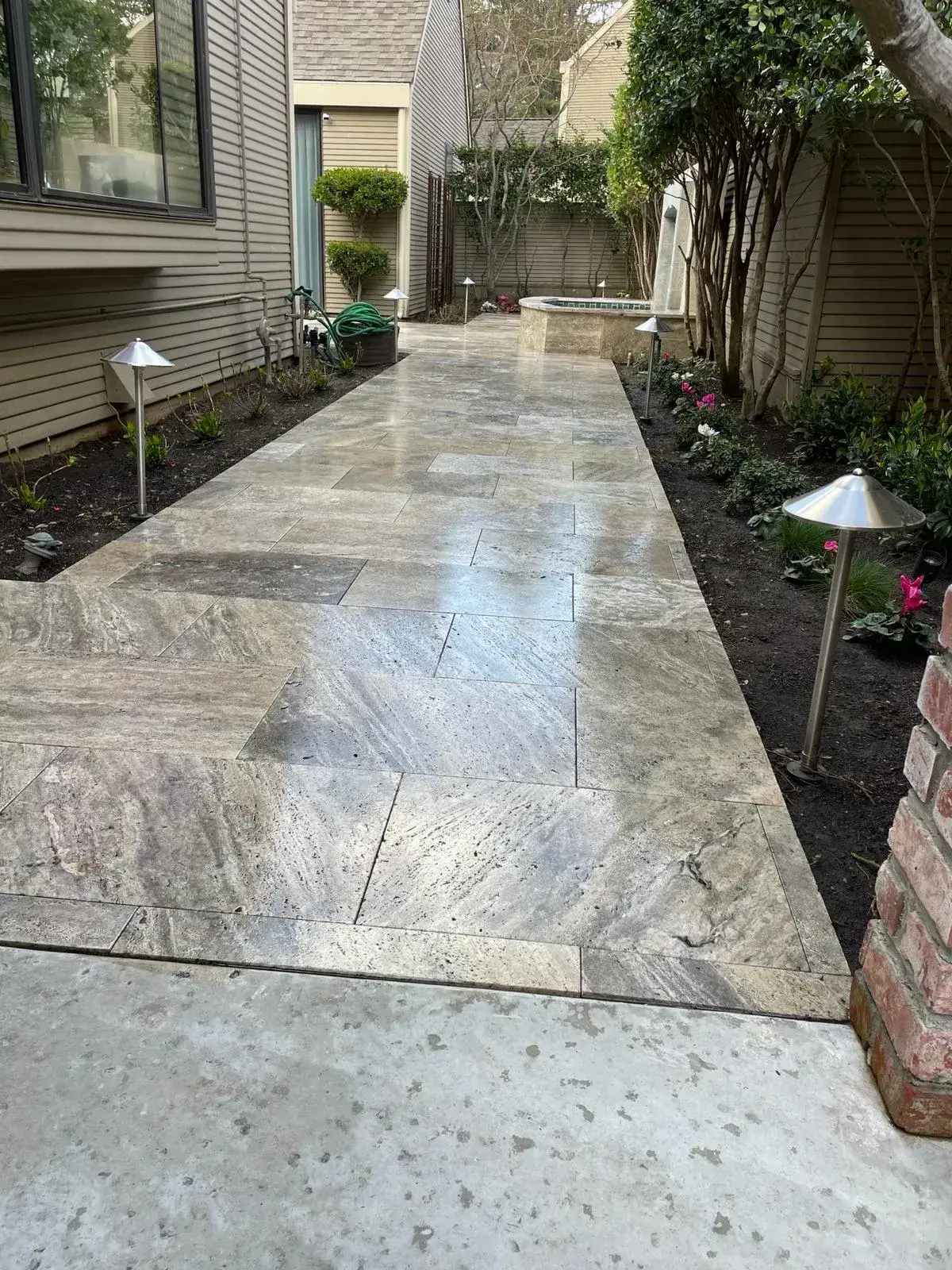 Stylish hardscape with patio and walkways enhancing a residential backyard, showcasing landscaping expertise