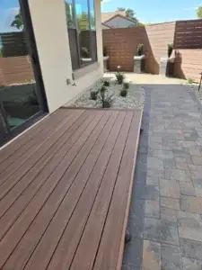 Homeowners consulting with a landscape contractor in a backyard setting
