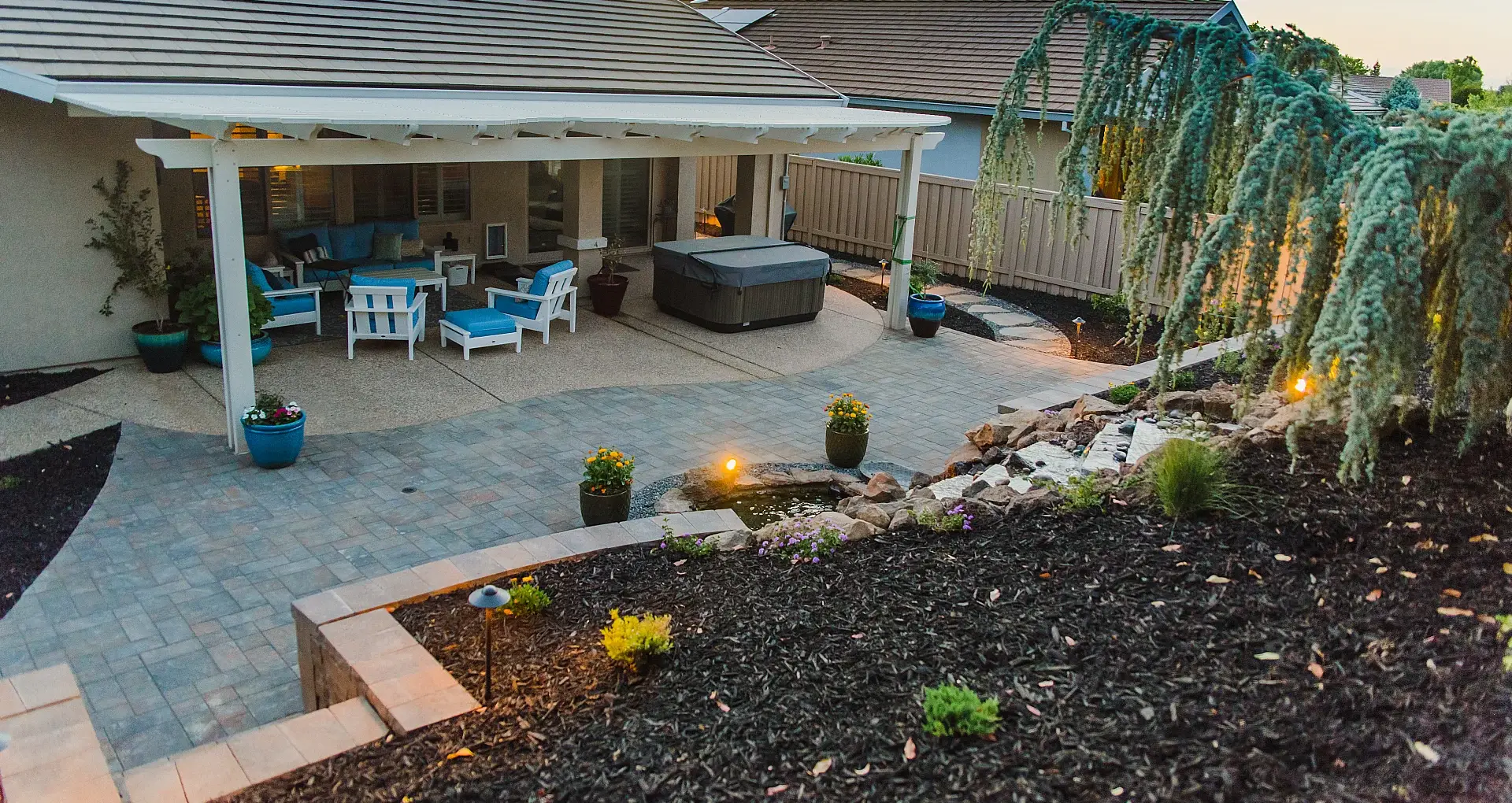 Custom concrete patio and steps with outdoor seating area and water feature in Rocklin, CA.